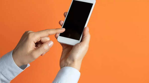 A hand holding a phone and scrolling with the index finger